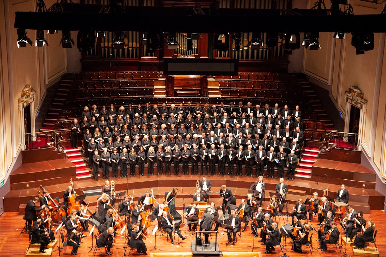 A majestic orchestra and choir performing at a historic venue in Edinburgh, Scotland.